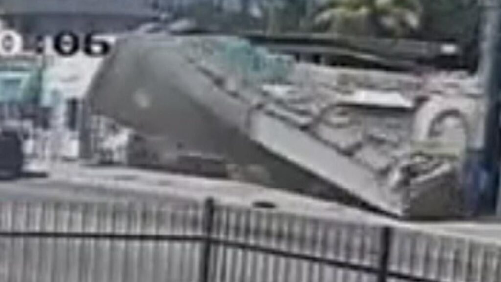 CCTV: Front of roof collapses into Miami street narrowly missing traffic