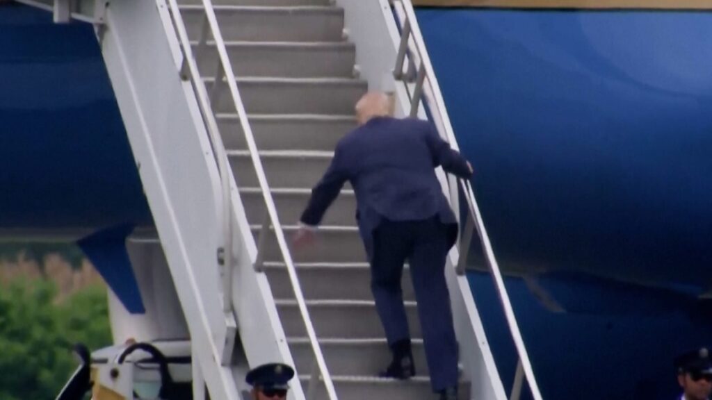 Trump stumbles up the stairs to Air Force One, stoking memory of Biden tripping video